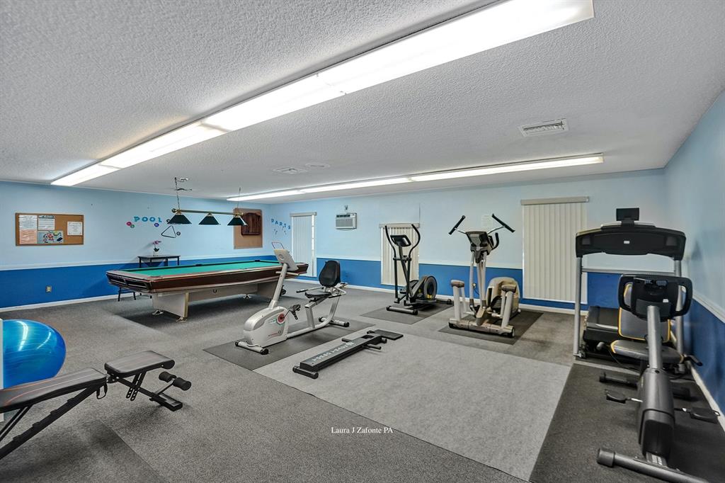 331 Northwest 76th Avenue, Unit 104 Margate, FL 33063 - Photo 26 of 30 a view of a room with gym equipment