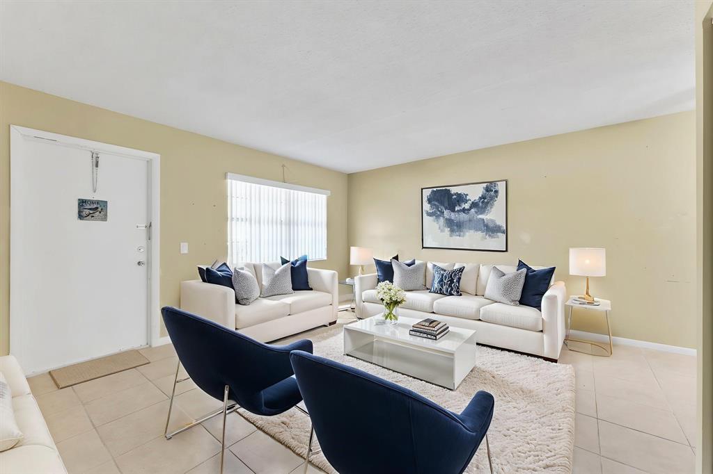 331 Northwest 76th Avenue, Unit 104 Margate, FL 33063 - Photo 7 of 30 a living room with furniture a large window and a table