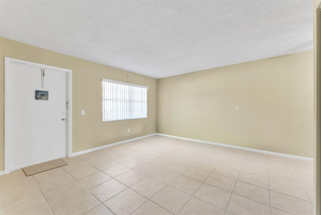 331 Northwest 76th Avenue, Unit 104 Margate, FL 33063 - Photo 8 of 30 an empty room with windows