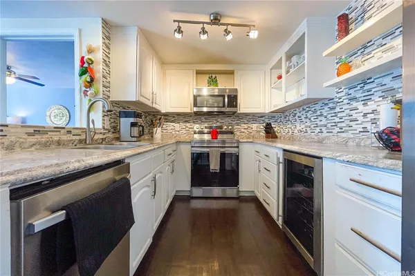 a kitchen with a stove top oven sink and cabinets