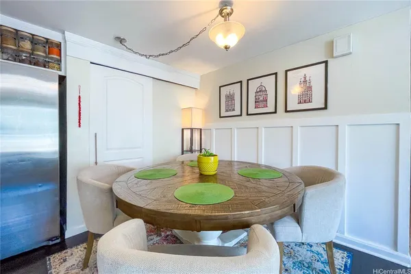 a dining room with furniture and a mirror