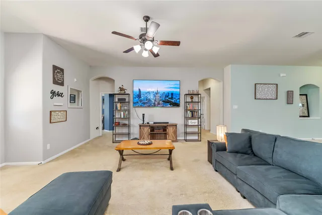 a living room with furniture a rug and white walls