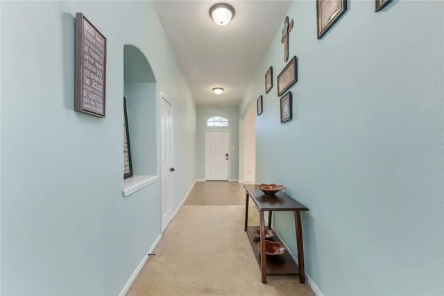 a front view of a house with a garden and trees