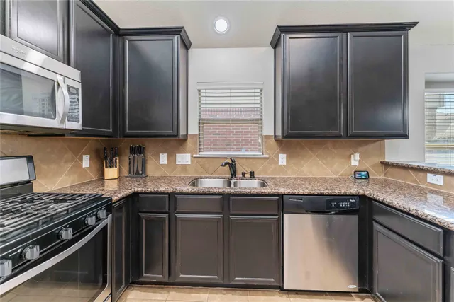 a living room with furniture a ceiling fan and a window