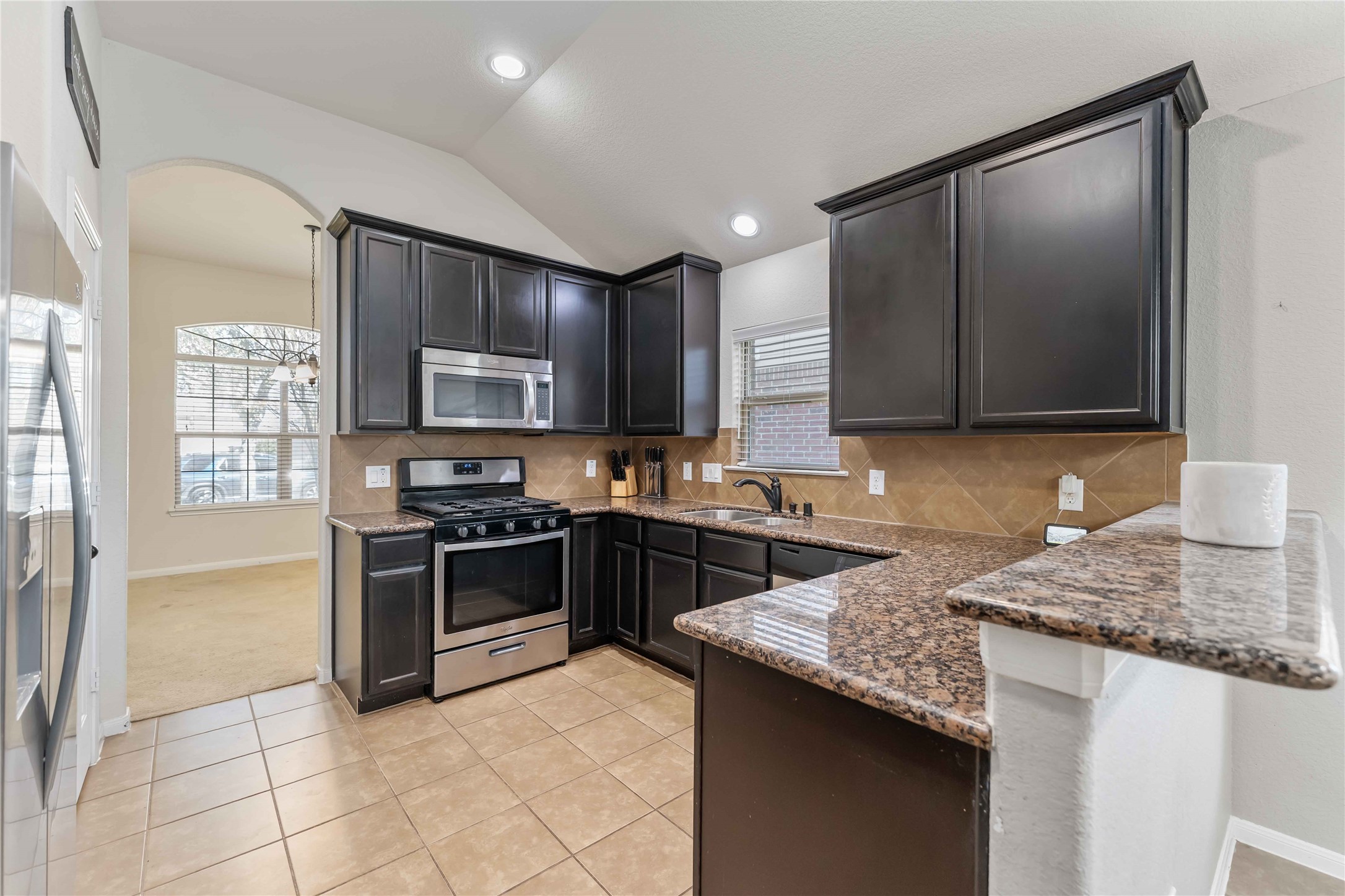 8226 Silent Deep Drive Rosenberg, TX 77469 - Photo 5 of 23 a kitchen with stainless steel appliances granite countertop a stove microwave and sink