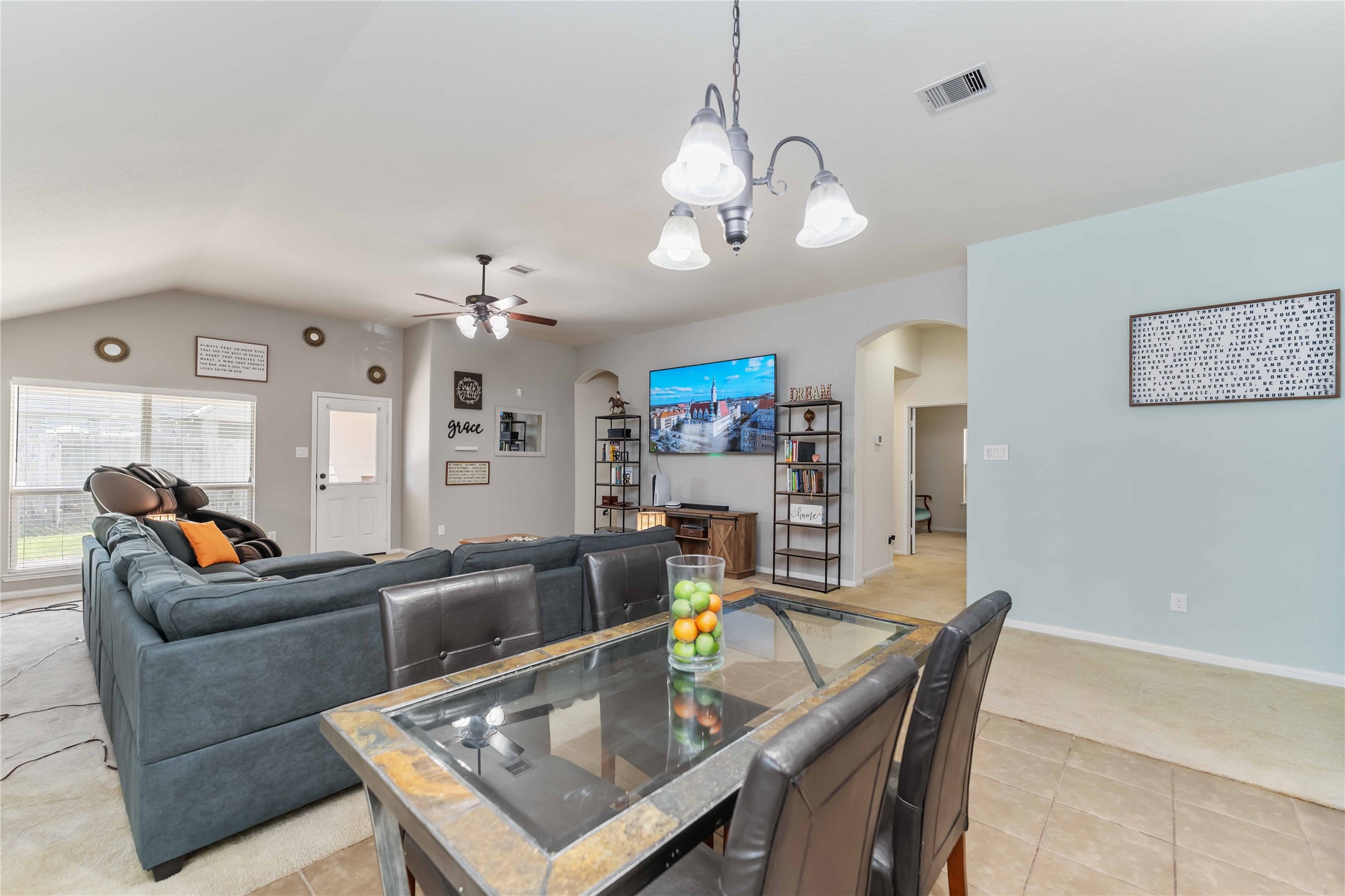 8226 Silent Deep Drive Rosenberg, TX 77469 - Photo 9 of 23 a living room with furniture a chandelier and a dining table