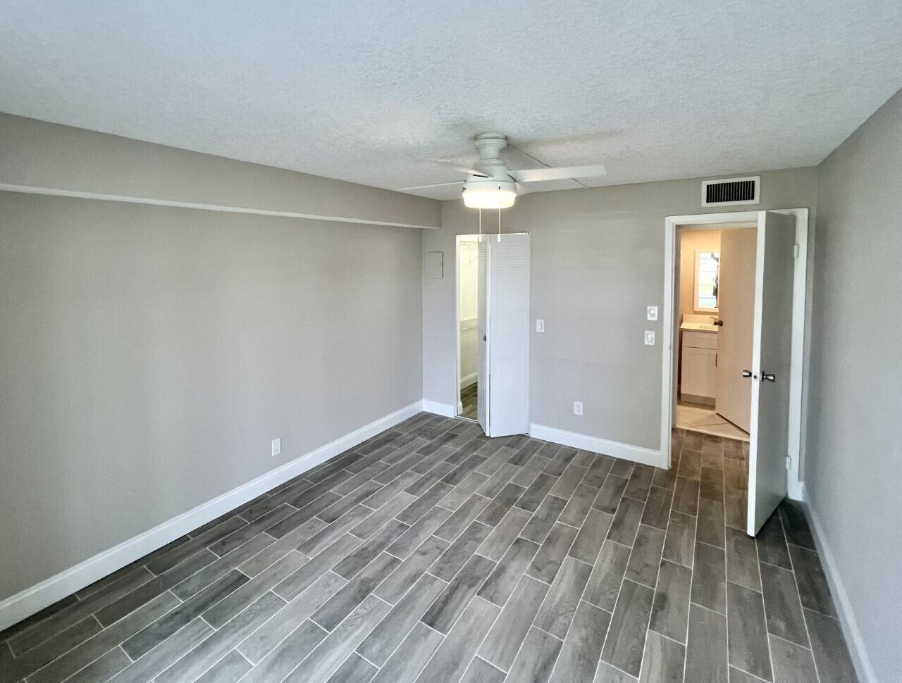 20 Saxony A, Unit A Delray Beach, FL 33446 - Photo 13 of 50 wooden floor in an empty room with a window