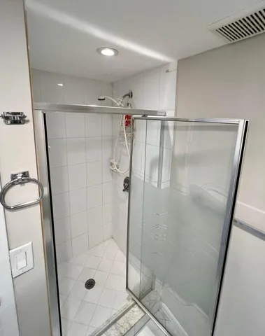 a bathroom with a glass door shower