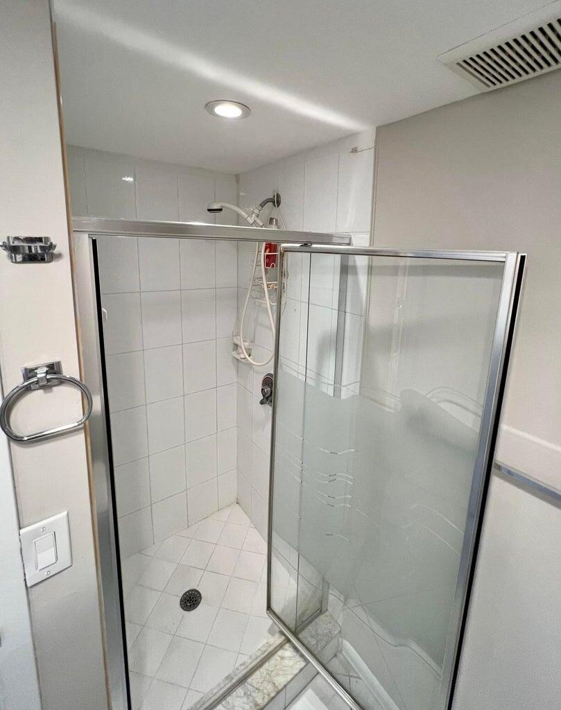 20 Saxony A, Unit A Delray Beach, FL 33446 - Photo 16 of 50 a bathroom with a glass door shower