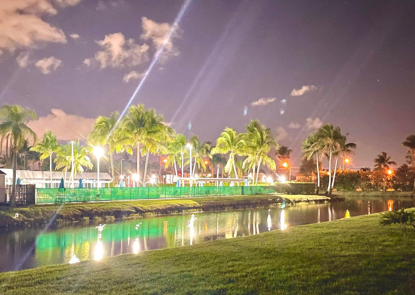 20 Saxony A, Unit A Delray Beach, FL 33446 - Photo 17 of 50 a view of a lake with a house in the background