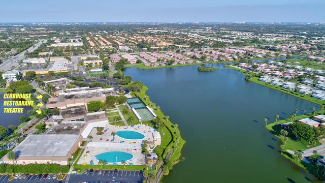 an aerial view of residential houses with outdoor space and river