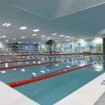 a front view of multi story residential apartment building with yard and outdoor seating