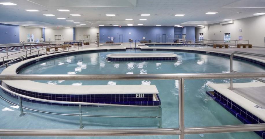 20 Saxony A, Unit A Delray Beach, FL 33446 - Photo 29 of 50 a kitchen with kitchen island a sink and a stove