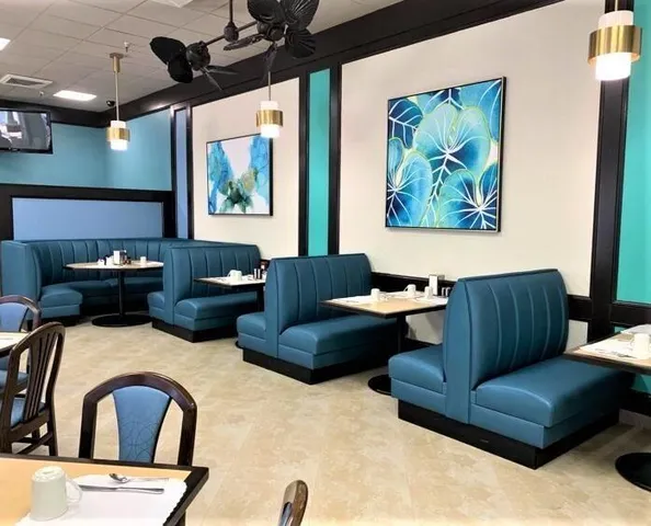 a patio with a table and chairs and potted plants