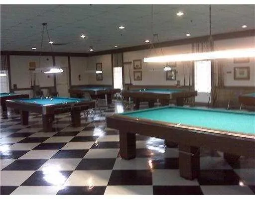 a view of a big yard with plants and large trees