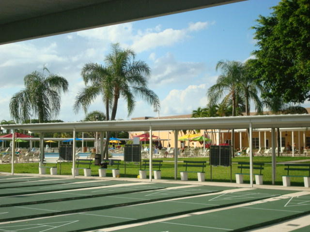 20 Saxony A, Unit A Delray Beach, FL 33446 - Photo 41 of 50 a view of a swimming pool with a garden