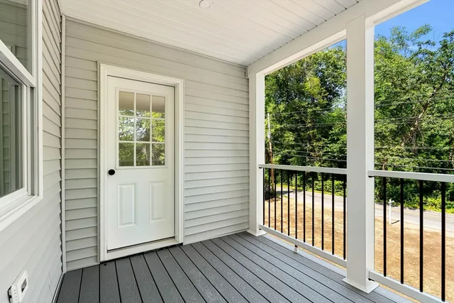 a view of porch with wooden floor