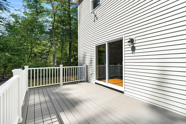 a view of backyard with deck and wooden floor