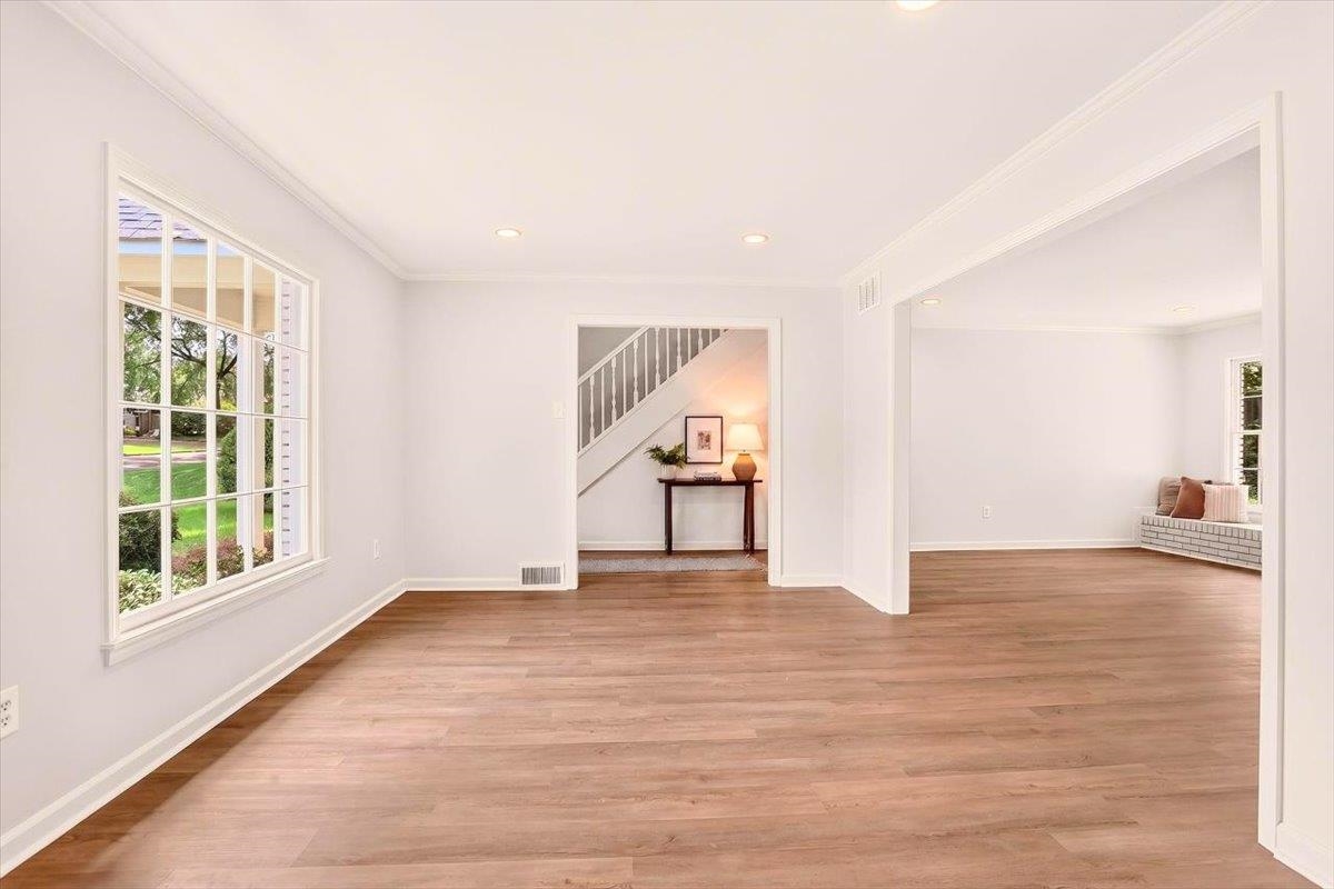 7674 Apple Valley Road Germantown, TN 38138 - Photo 3 of 15 Spacious room featuring wood-finish flooring, white walls, and crown molding