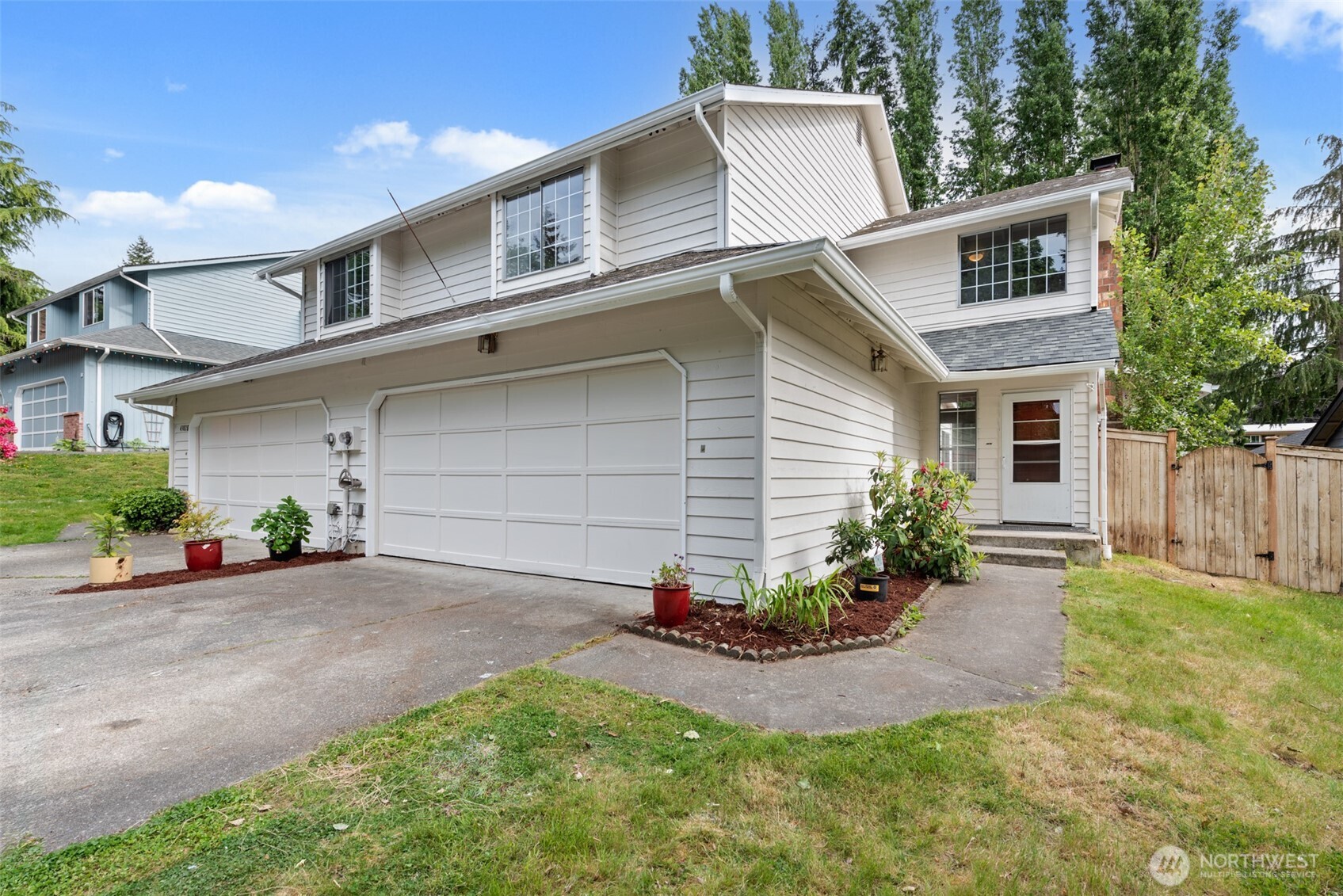 4302 155th Street Southwest Lynnwood, WA 98087 - Photo 1 of 19 a front view of house with yard and trees in the background