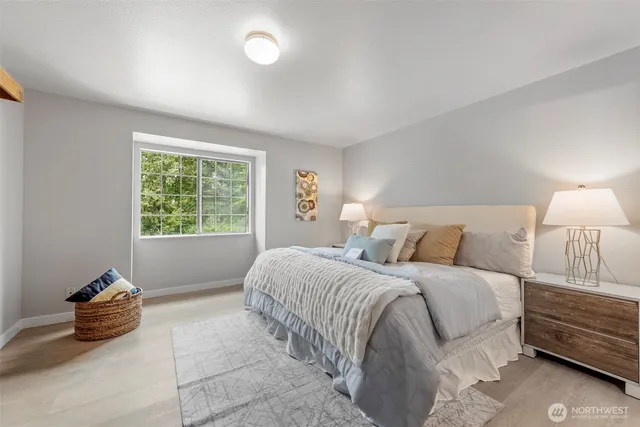 a spacious bedroom with a bed and a window