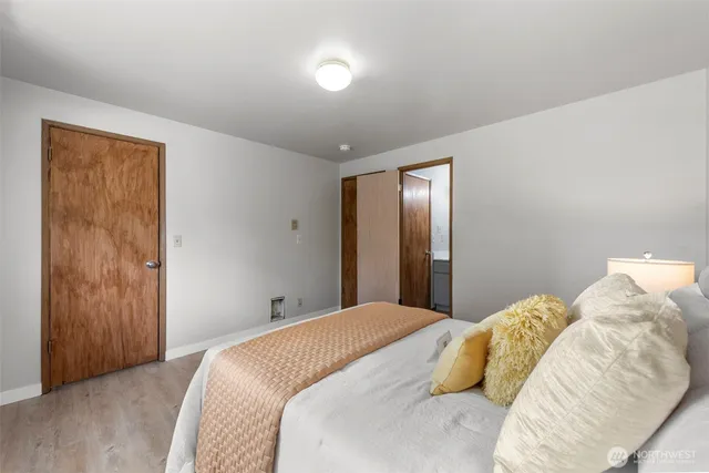 a bedroom with a bed and a mirror