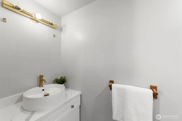 a bathroom with a white sink and a mirror