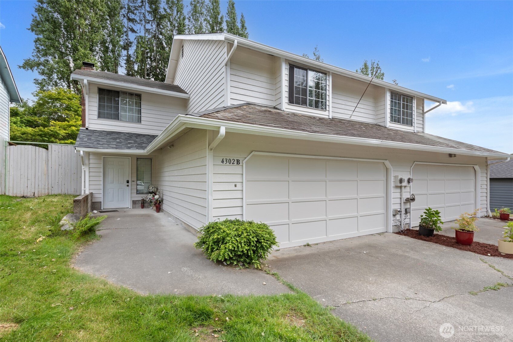 4302 155th Street Southwest Lynnwood, WA 98087 - Photo 2 of 19 a front view of a house with a yard and garage