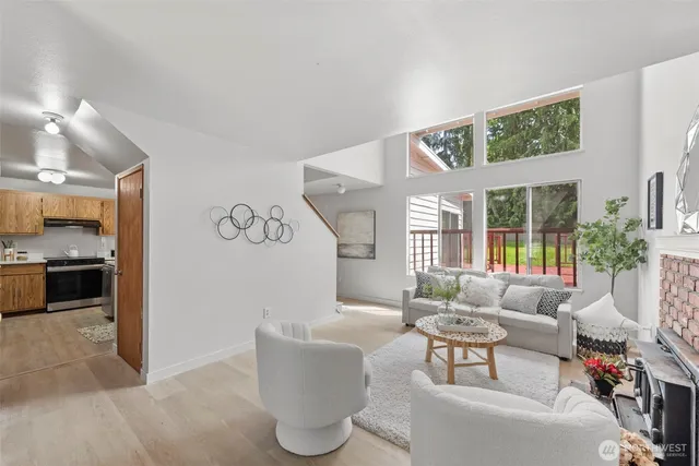 a living room with furniture a large window and a flat screen tv