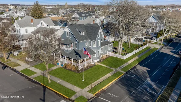 an aerial view of a tennis ground with a white house