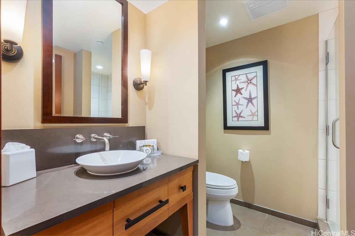 92-104 Waialii Place, Unit O422 Kapolei, HI 96707 - Photo 15 of 25 a bathroom with a toilet a sink and mirror