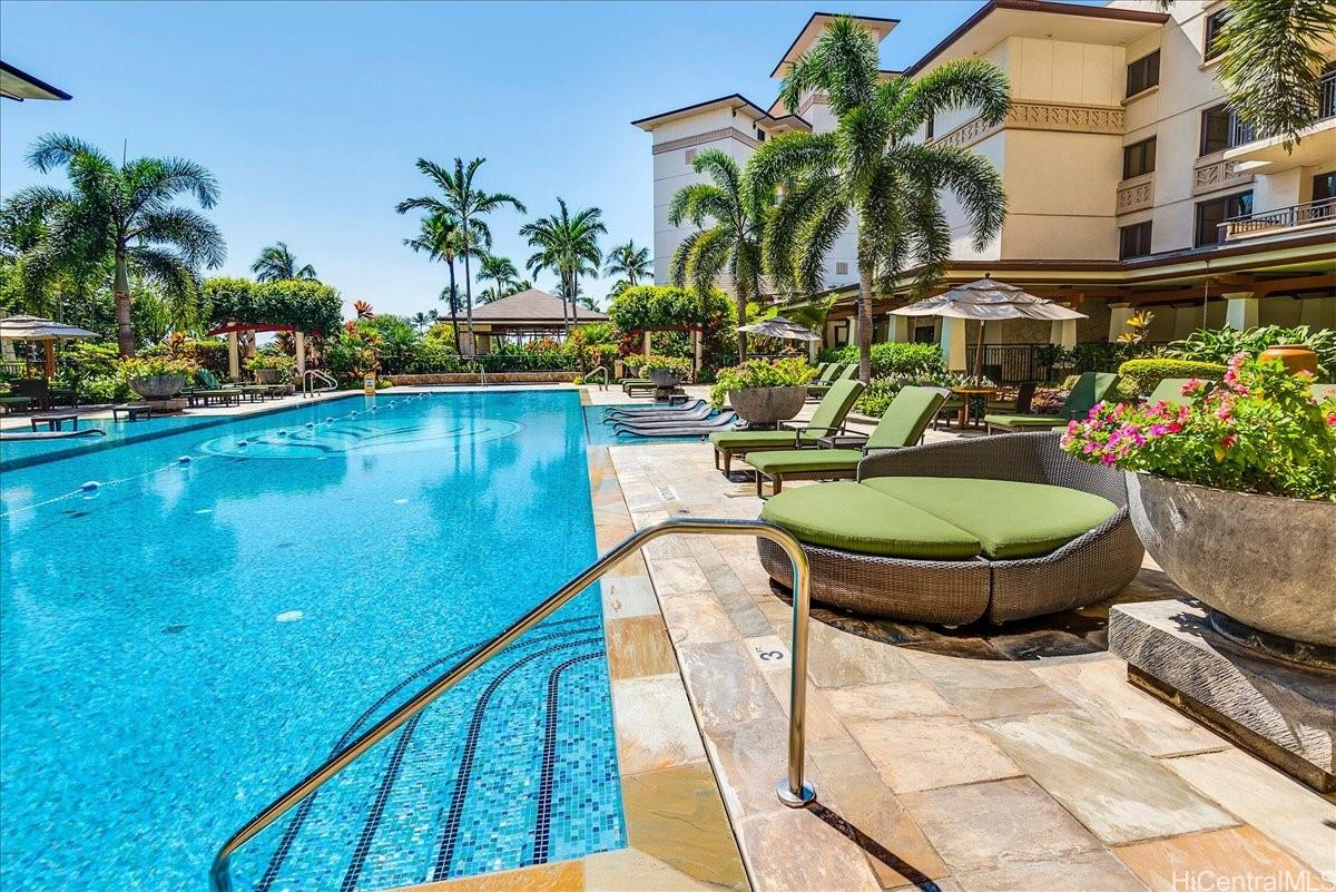 92-104 Waialii Place, Unit O422 Kapolei, HI 96707 - Photo 18 of 25 a swimming pool with outdoor seating and plants
