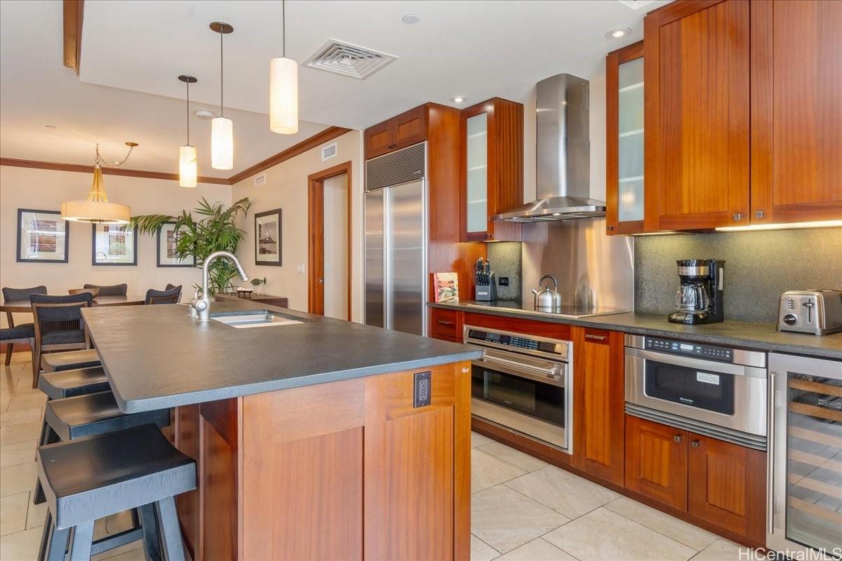 92-104 Waialii Place, Unit O422 Kapolei, HI 96707 - Photo 6 of 25 a kitchen with stainless steel appliances granite countertop a sink and cabinets