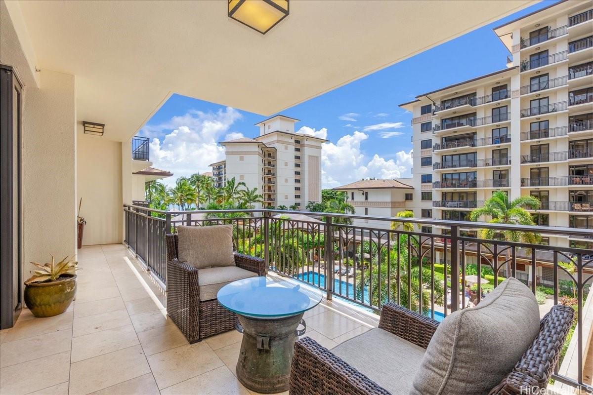 92-104 Waialii Place, Unit O422 Kapolei, HI 96707 - Photo 9 of 25 a view of a balcony with two chairs and a potted plant