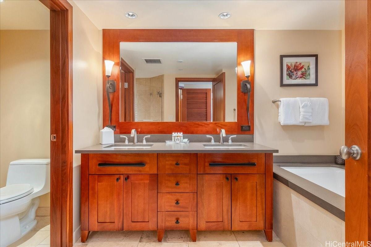 92-104 Waialii Place, Unit O422 Kapolei, HI 96707 - Photo 10 of 25 a bathroom with a granite countertop sink and a mirror