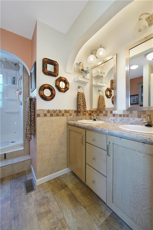 195 Elm Road Avella, PA 15312 - Photo 13 of 25 The MASTER BATH with double bowl and vanity and Autumn Carnival laminate countertop is attractive with its stylish accessories, flooring and double lights.