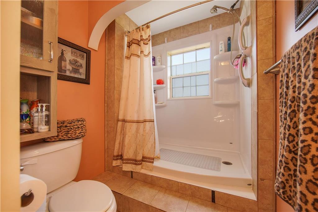 195 Elm Road Avella, PA 15312 - Photo 14 of 25 Splish splash, I was taking a shower in this gorgeous MAIN BATH. Bold and beautiful with its curved bulkhead and vibrant colors. The tub was purposely converted to a large walk-in shower.