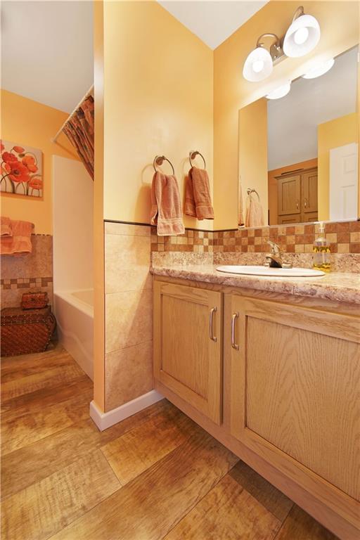 195 Elm Road Avella, PA 15312 - Photo 17 of 25 MAIN BATHROOM with shower/tub combination has attractive laminate flooring and beautiful countertops and backsplash.