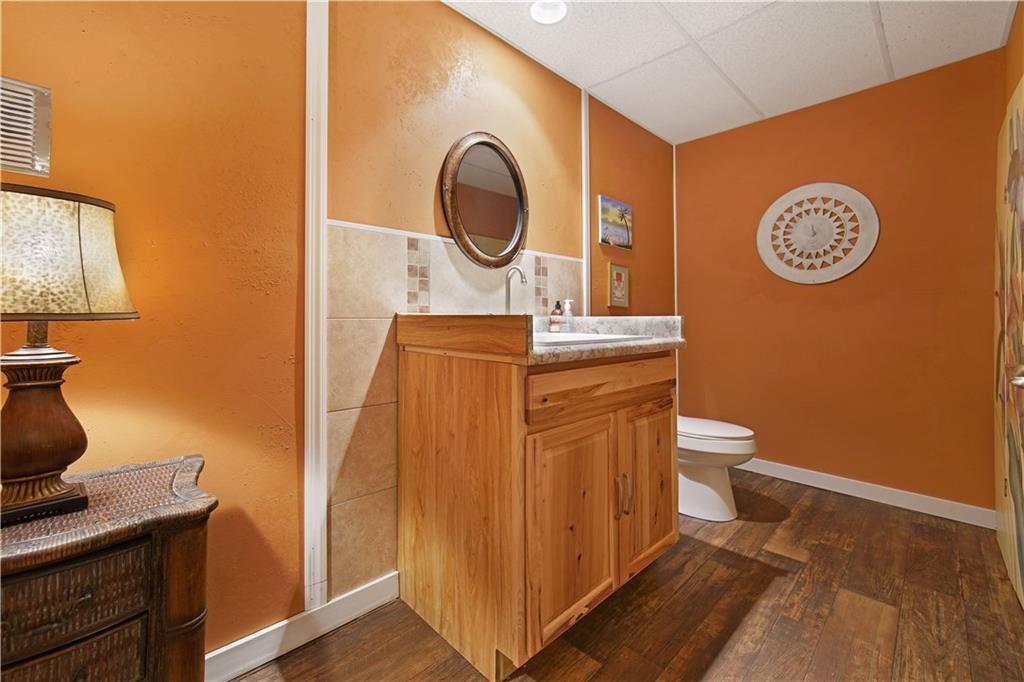 195 Elm Road Avella, PA 15312 - Photo 23 of 25 Located in the downstairs GAMEROOM is the powder room with its ceramic tile backsplash and strong congoleum flooring. Lots of room for accessorizing.