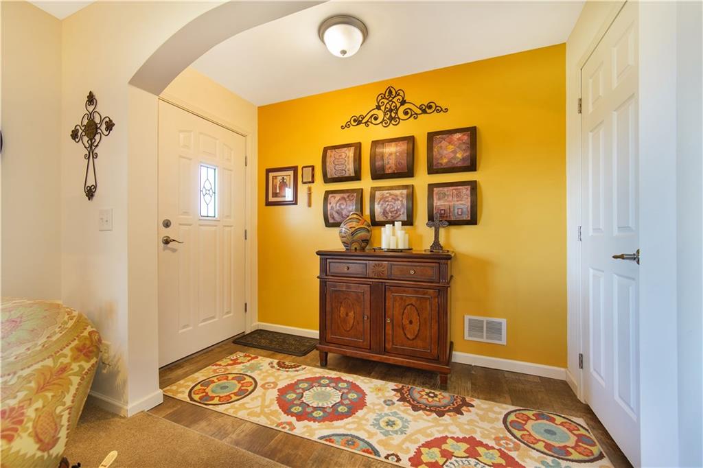 195 Elm Road Avella, PA 15312 - Photo 5 of 25 The bold ENTRYWAY invites you in. The painted wall and laminate flooring lead you to the storage closet. Take your coat off and stay a while.