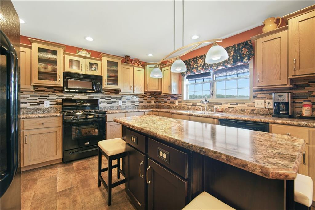 195 Elm Road Avella, PA 15312 - Photo 10 of 25 Another view of the KITCHEN shows more cabinet space under the island and a view of the kitchen window and sink. The overhead lighting is smart yet very effective.