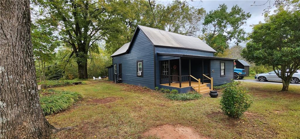 1458 Moccasin Gap Road Lula, GA 30554 - Photo 1 of 1 a view of a house with backyard and sitting area