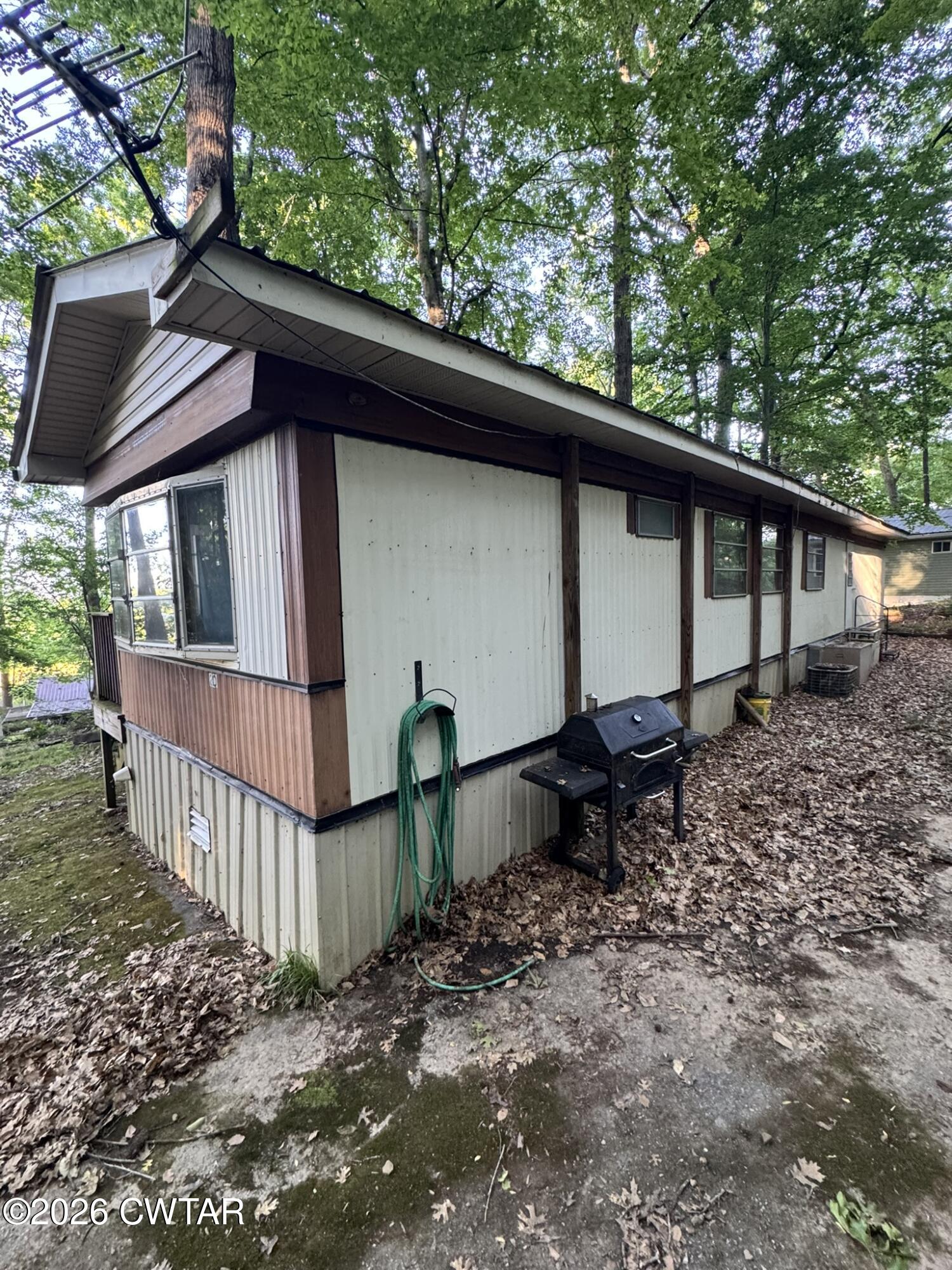 75 Elkins Road Decaturville, TN 38329 - Photo 2 of 8 a view of backyard with deck and outdoor seating