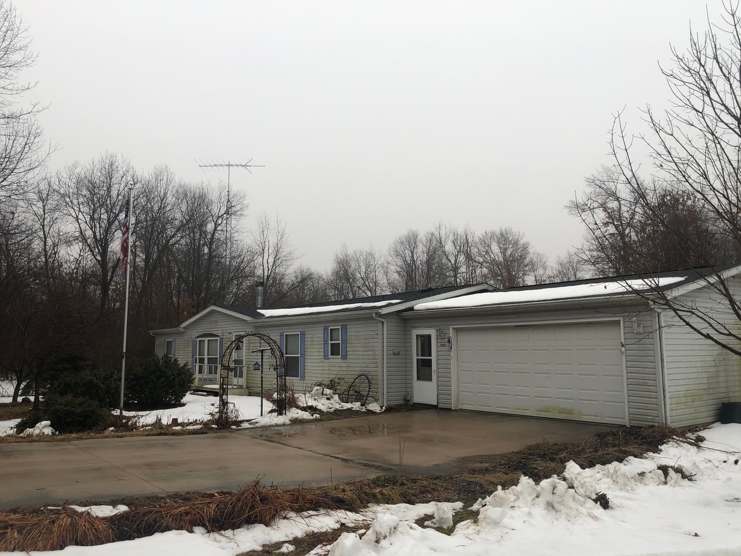 1043 Brewster Road Amboy, IL 61310 - Photo 1 of 17 a view of a house with a snow in the yard
