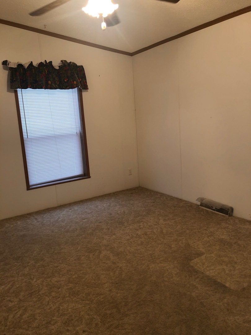 1043 Brewster Road Amboy, IL 61310 - Photo 8 of 17 an empty room with a door