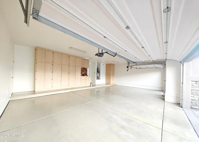 a view of a patio with couches and table and chairs under an umbrella