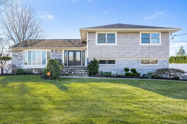 a front view of house with yard and green space