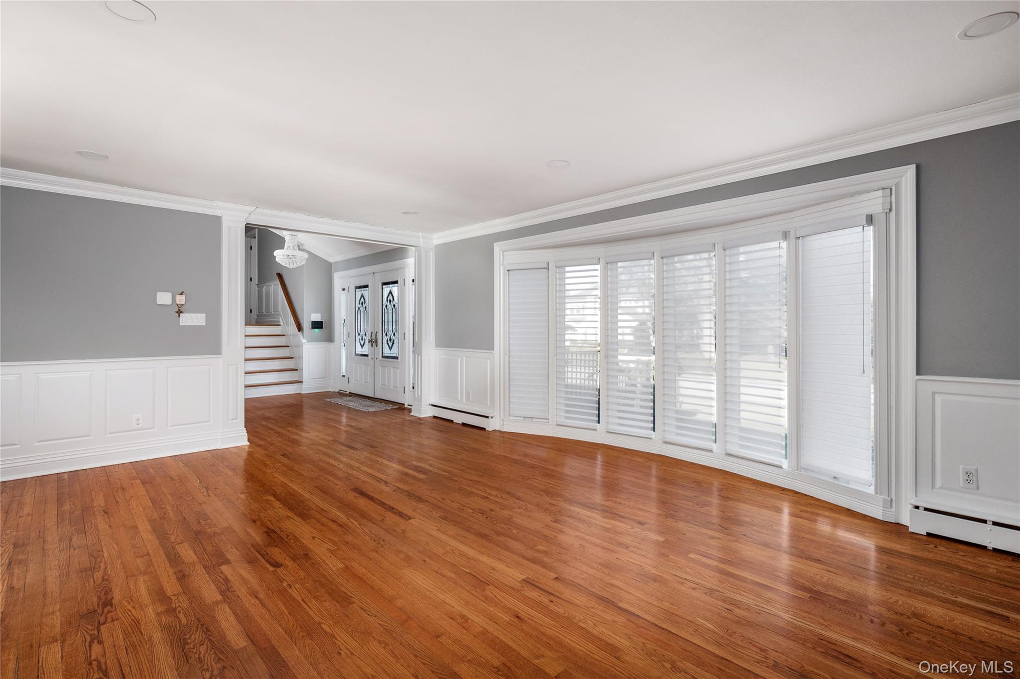 148 Exeter Road Massapequa, NY 11758 - Photo 11 of 28 a view of an empty room with wooden floor and a window