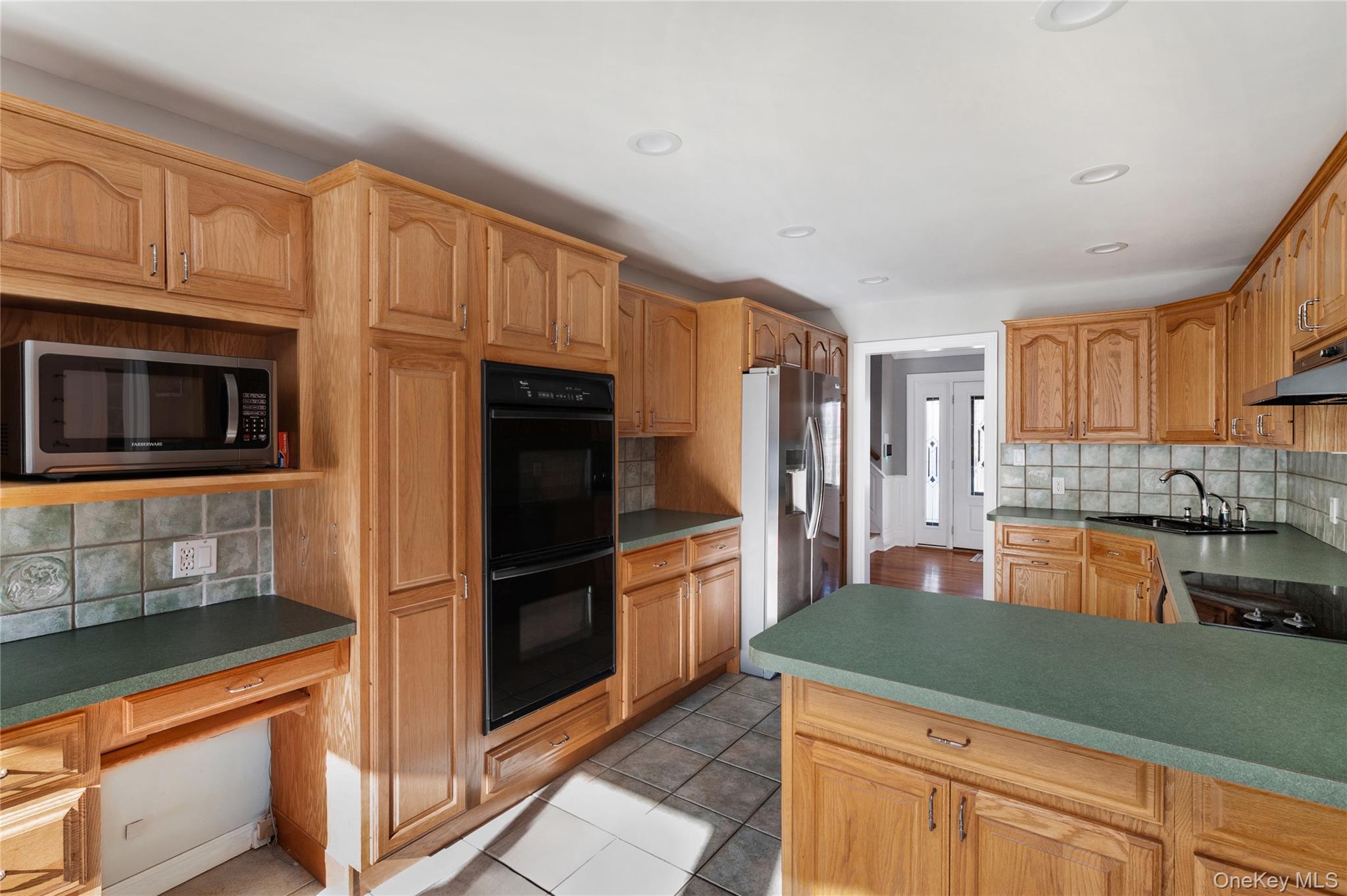 148 Exeter Road Massapequa, NY 11758 - Photo 14 of 28 a kitchen with granite countertop stainless steel appliances and counter space