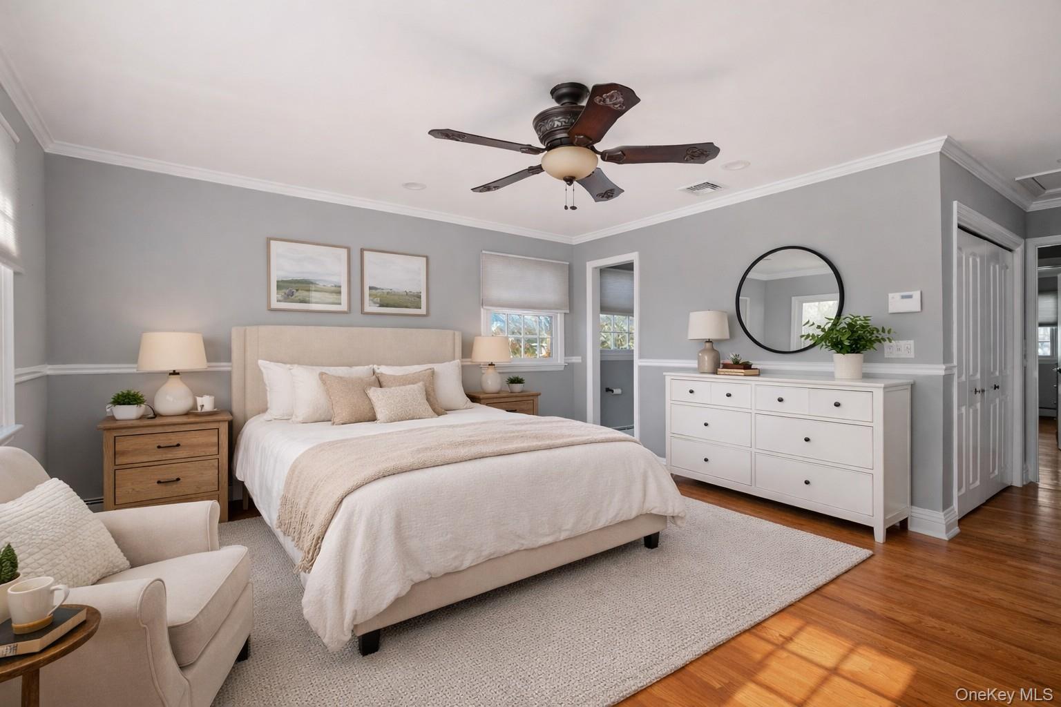 148 Exeter Road Massapequa, NY 11758 - Photo 16 of 28 a spacious bedroom with a bed a dresser with mirror